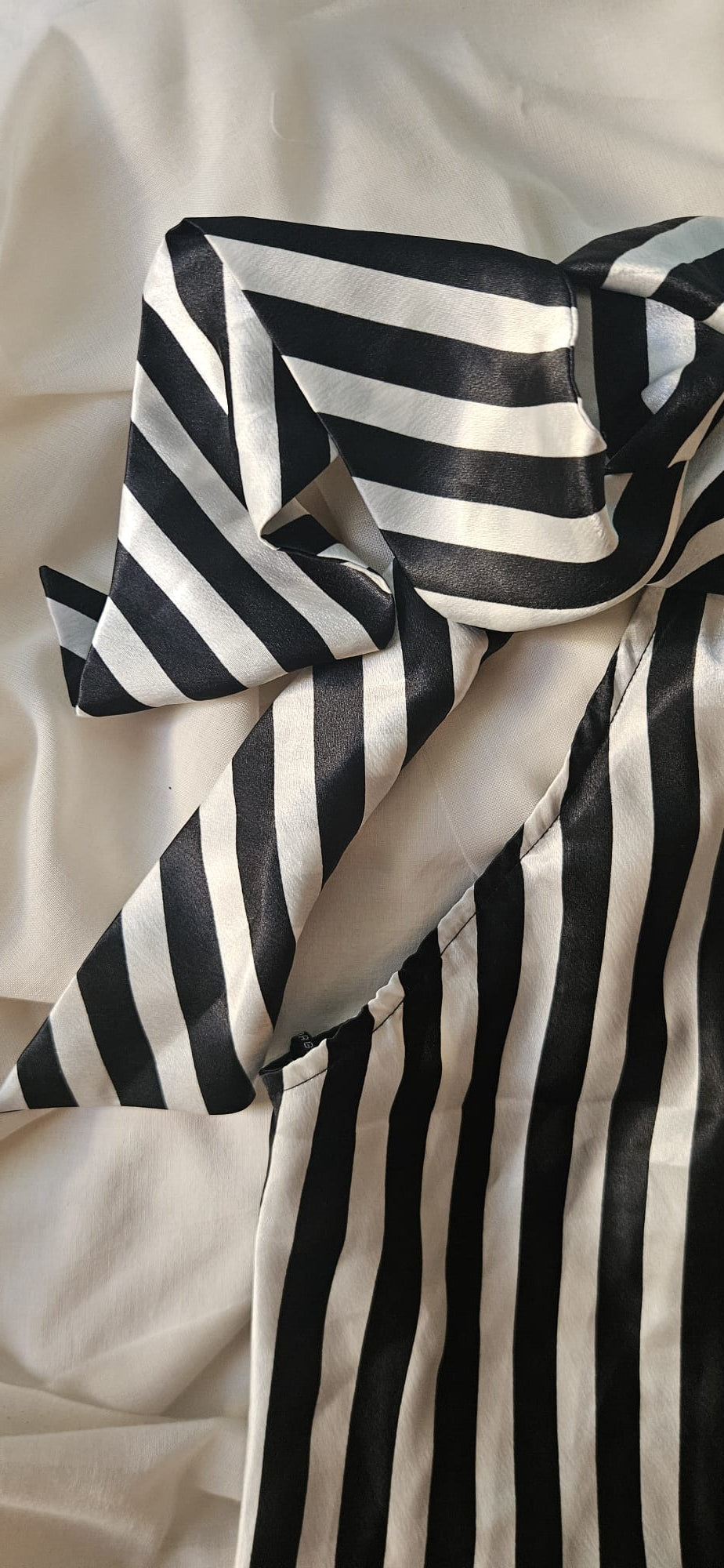 Close-up of black and white striped top with a soft focus background