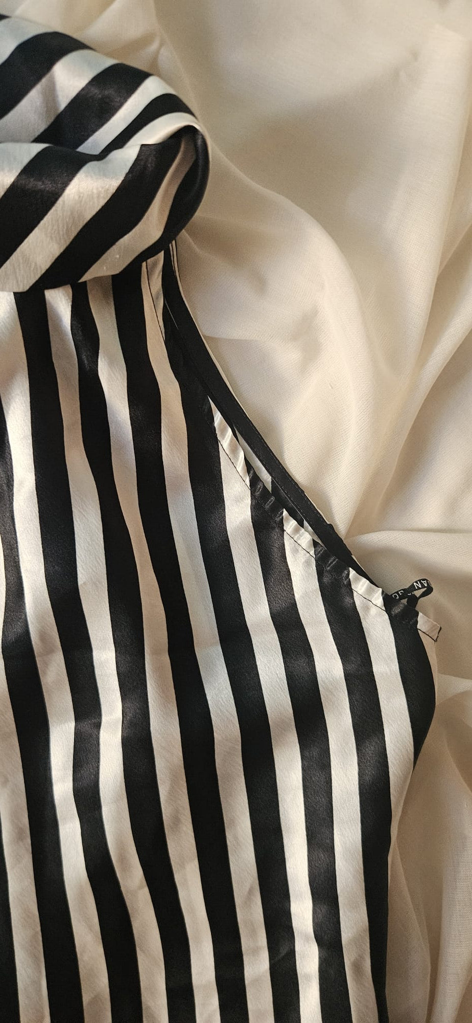 Black and white striped top on a beige background