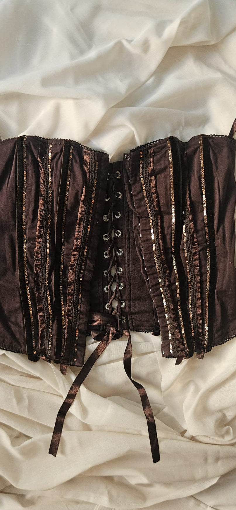 Brown corset on a white fabric background