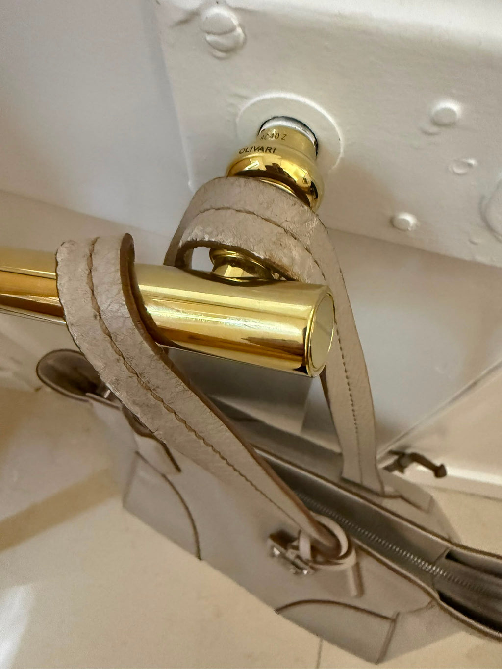 Coccinelle tote bag strap detail with gold hardware