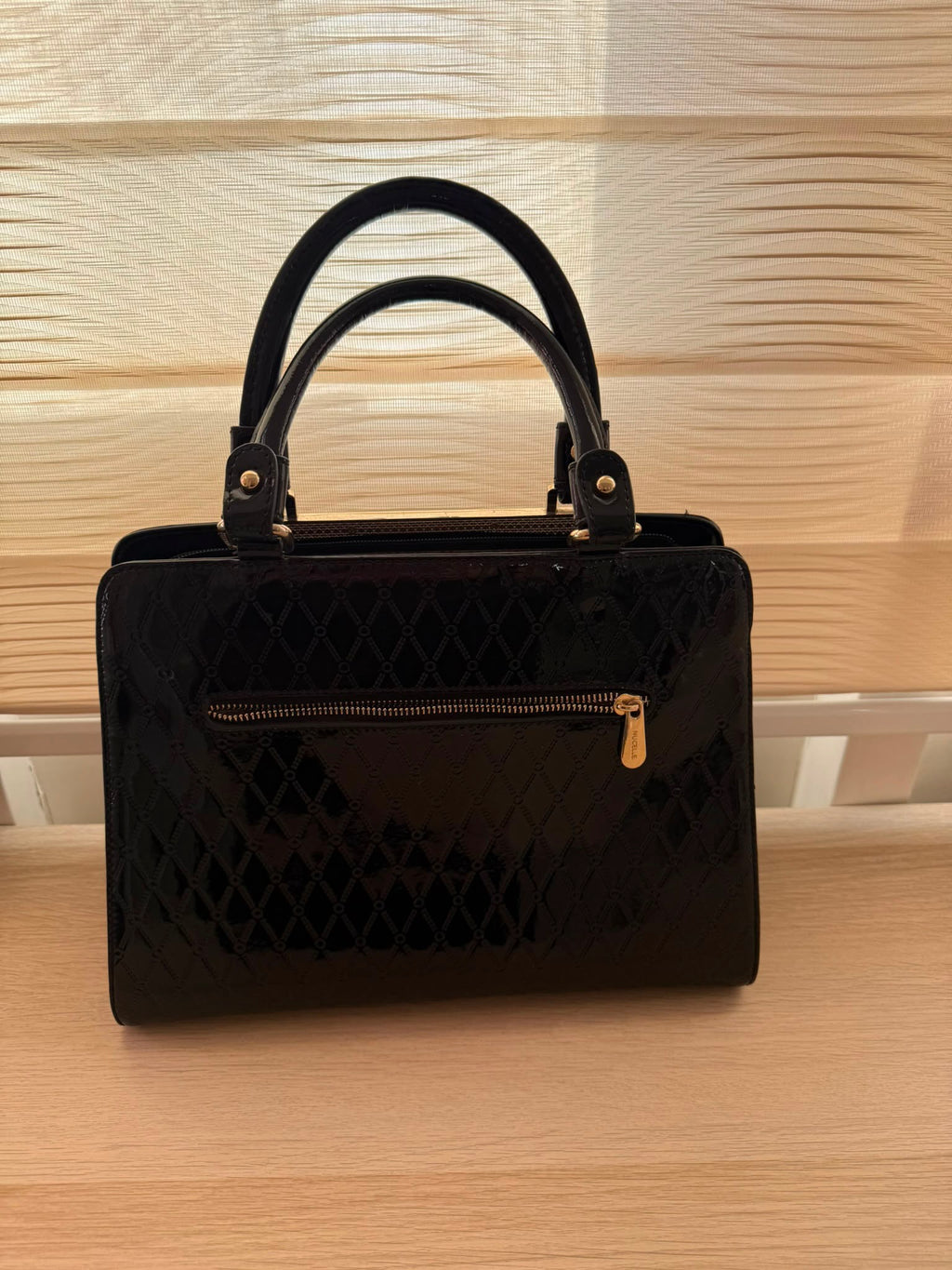 Black patent leather quilted handbag interior compartments