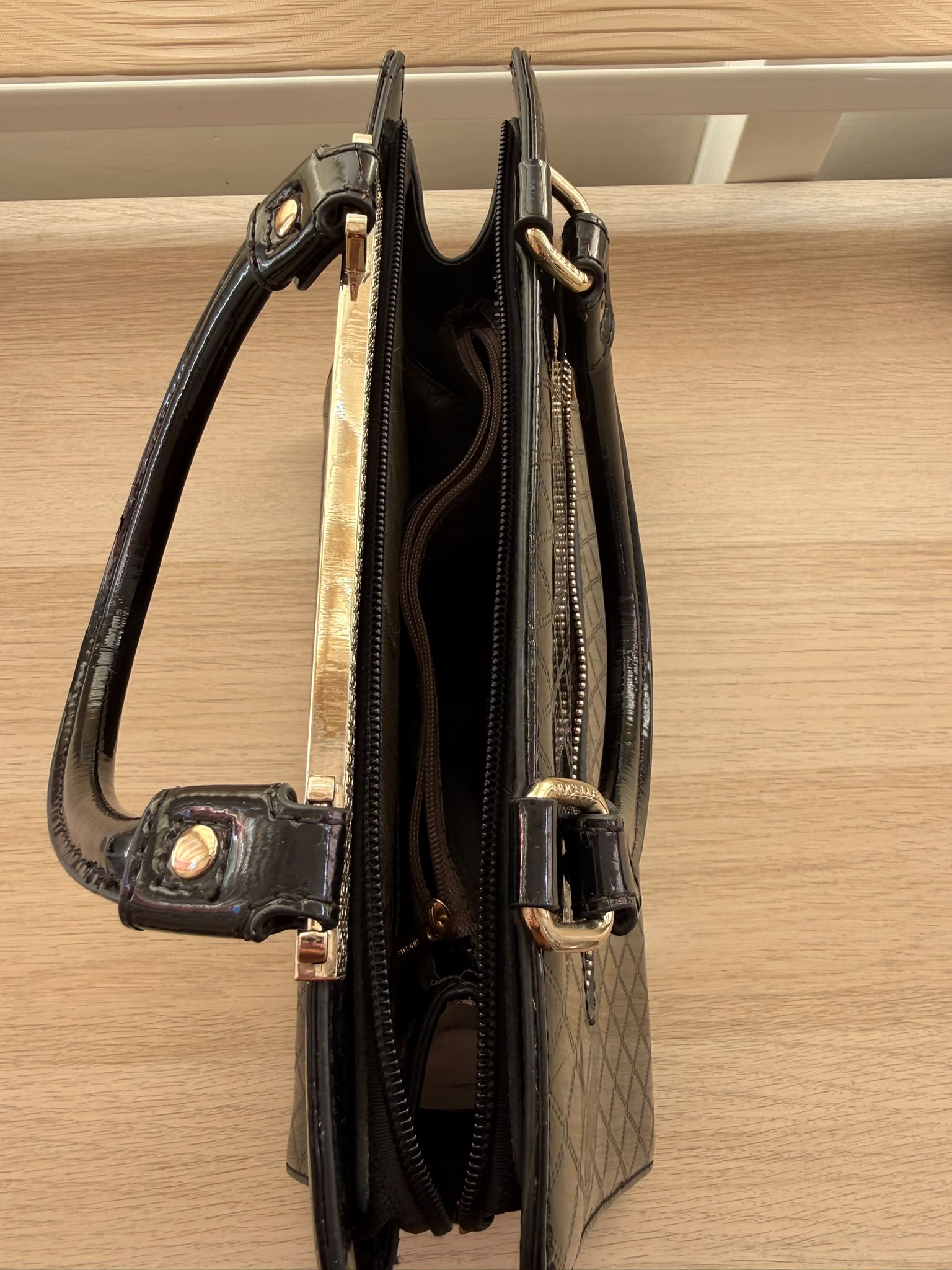 Black patent leather quilted handbag front view