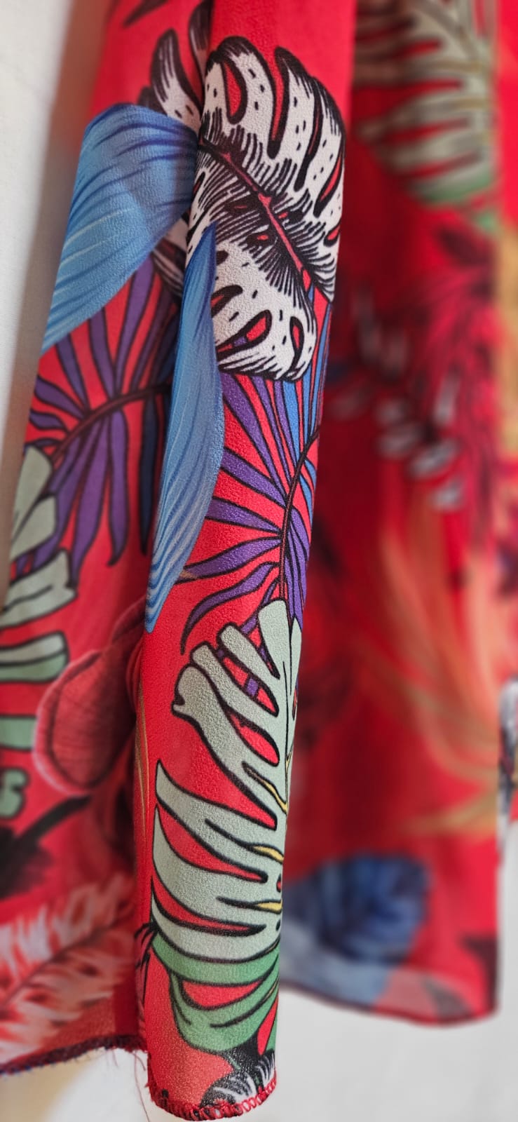 Colorful red dress with abstract patterns on a white background