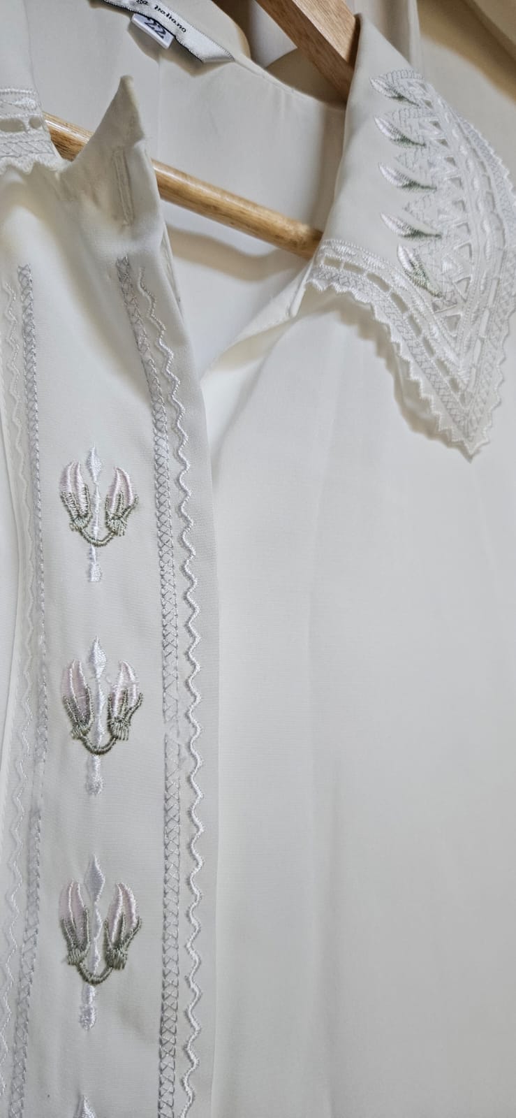 Silver embroidery and lace collar detail close-up