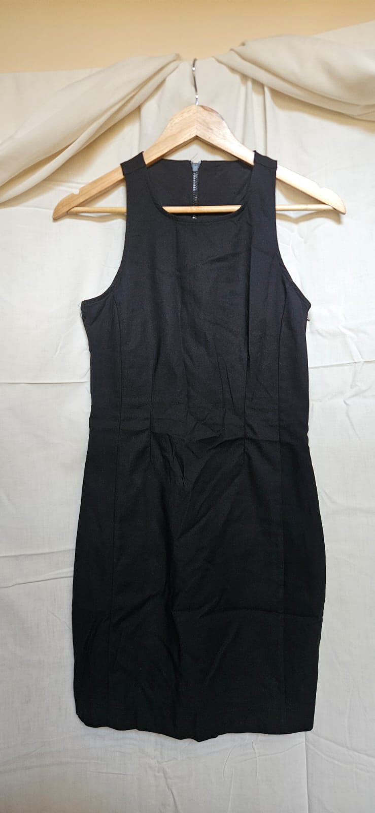 Black sleeveless pencil dress on hanger - front view
