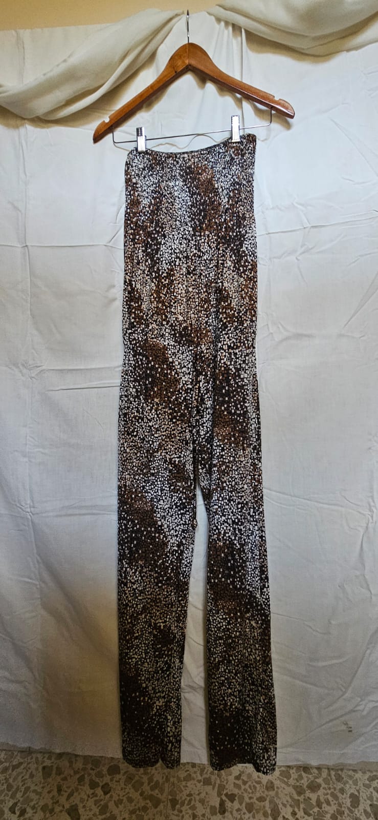 Brown and white mosaic print wide-leg trousers on hanger