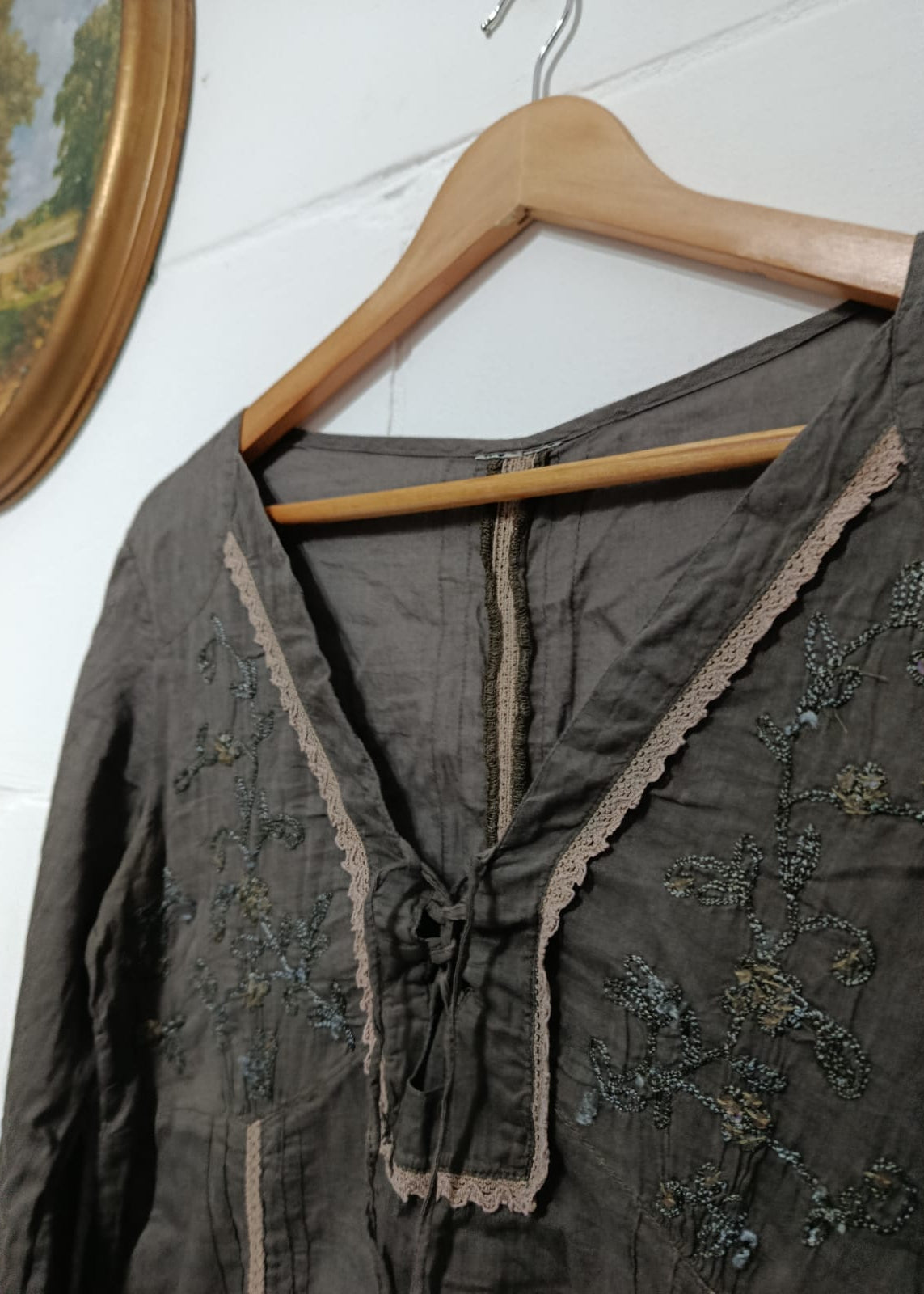 Close-up of charcoal blouse with tonal embroidery and lace-trimmed neckline