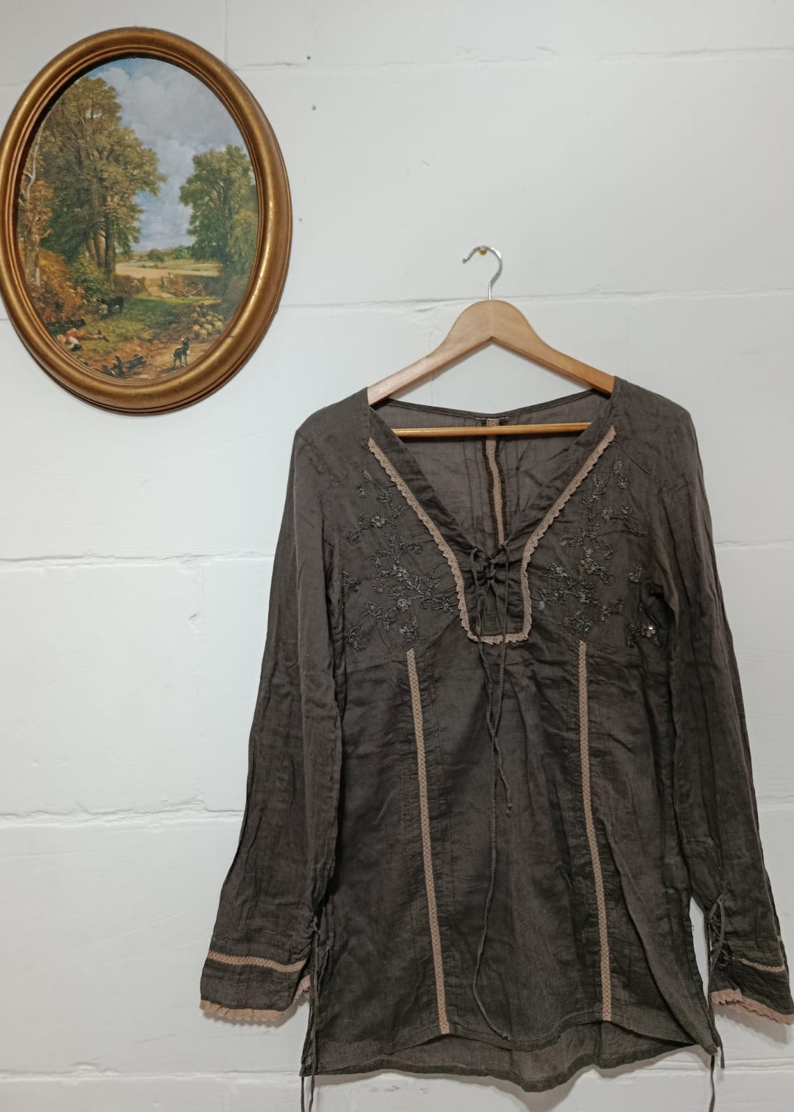 Full view of a charcoal long-sleeve embroidered blouse, one size fits S-M