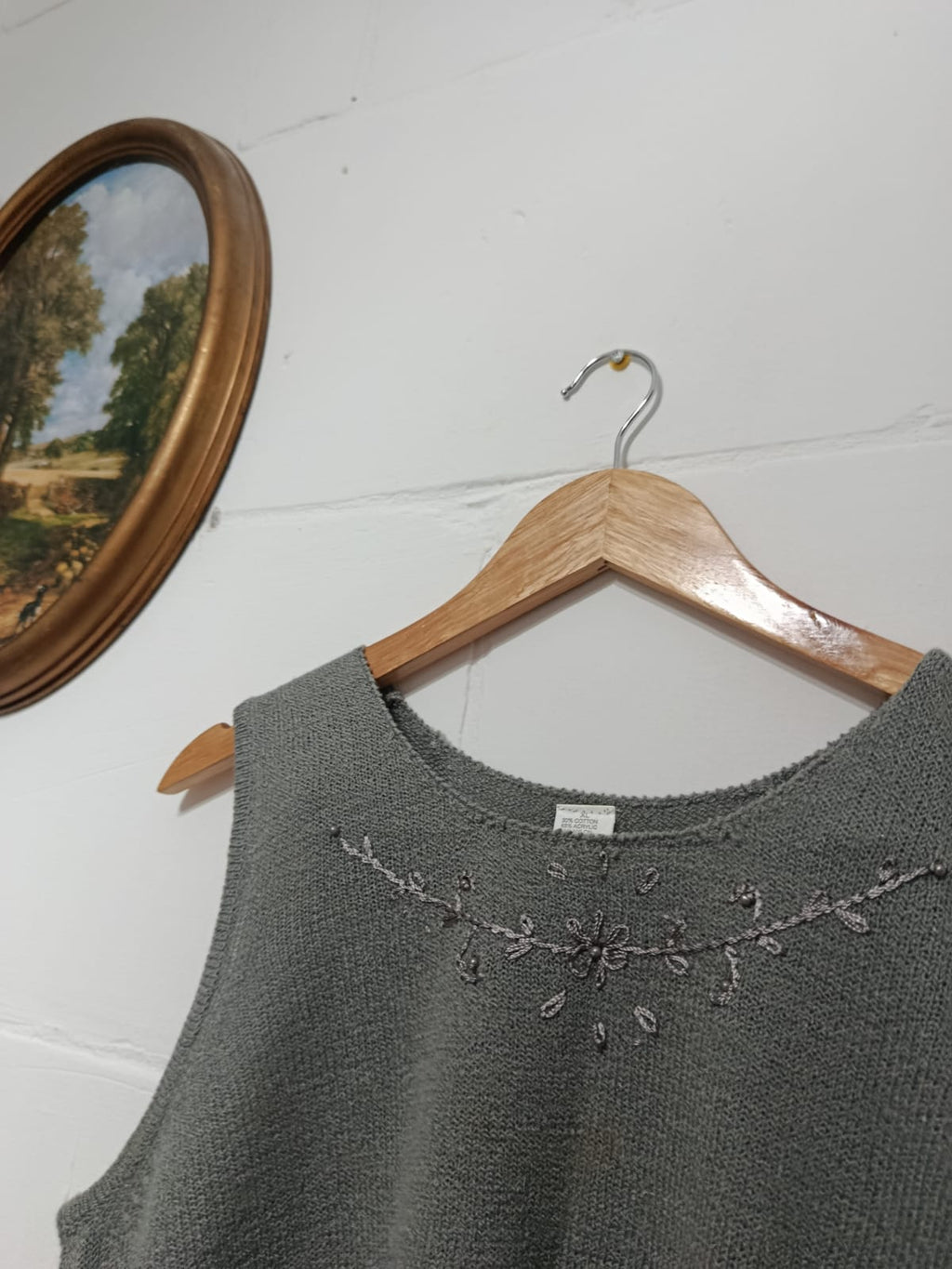 Close-up of floral embroidery around the neckline of a grey knit set